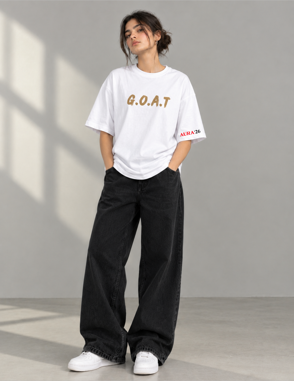 A woman modeling a white oversized t-shirt with 'G.O.