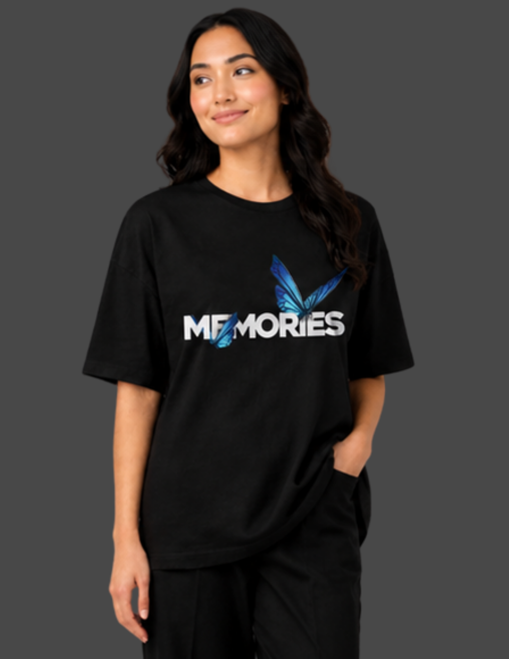 Person wearing a black t-shirt with 'MEMORIES' printed on it against a dark background