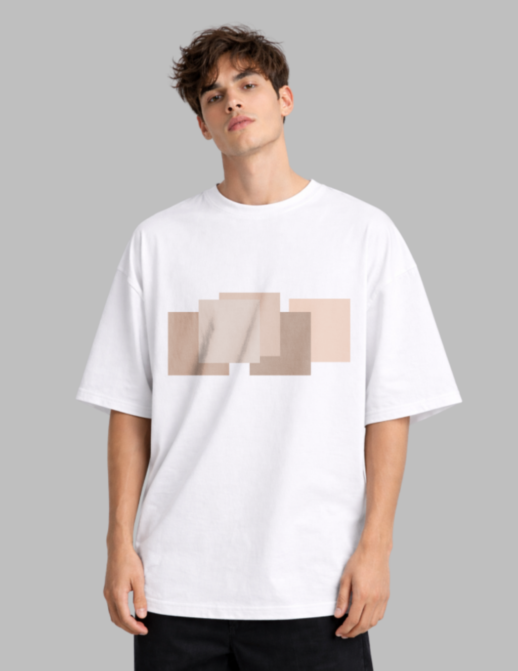 Man wearing a white t-shirt with a beige geometric design on a gray background