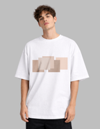 Man wearing a white t-shirt with a beige geometric design on a gray background