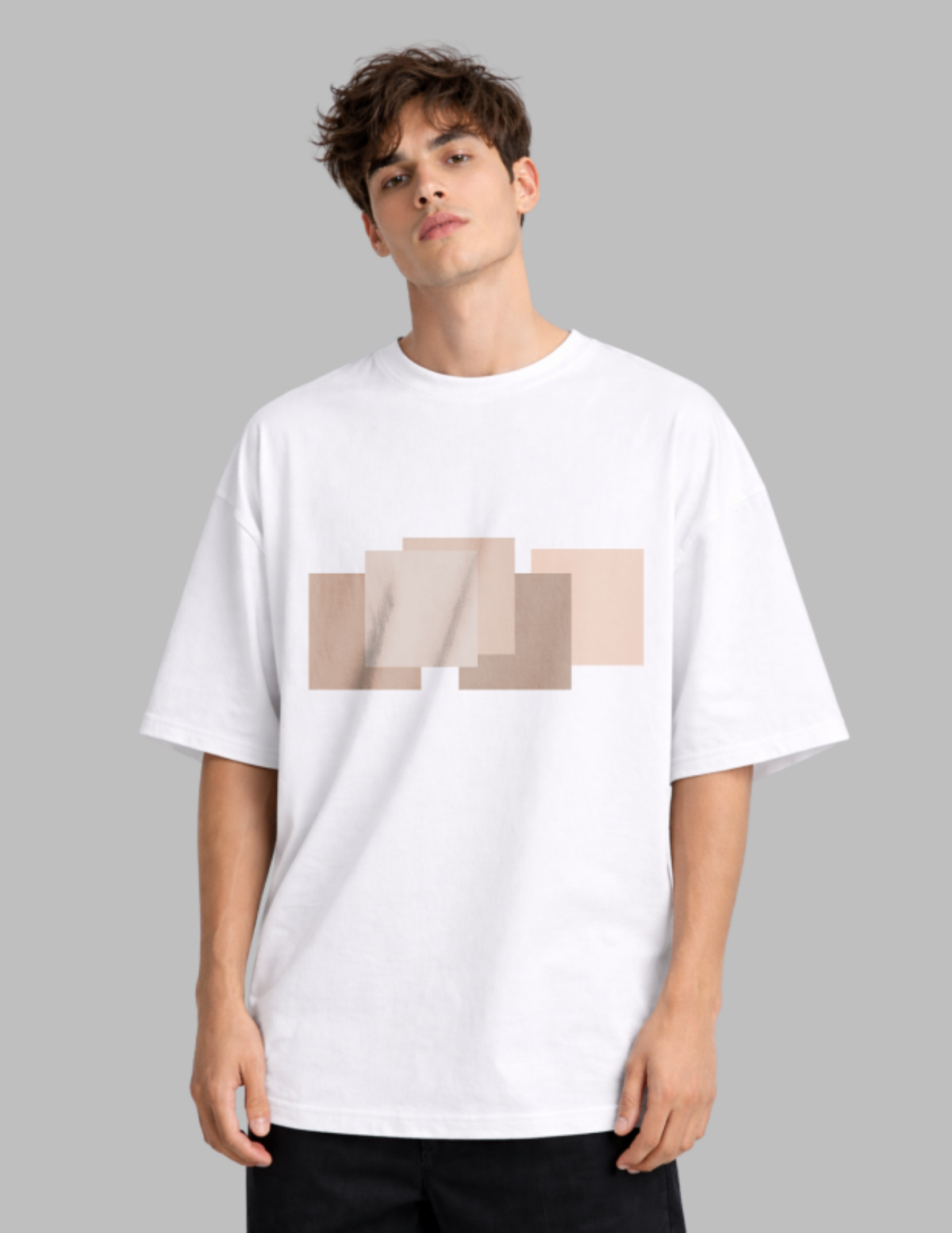 Man wearing a white t-shirt with a beige geometric design on a gray background