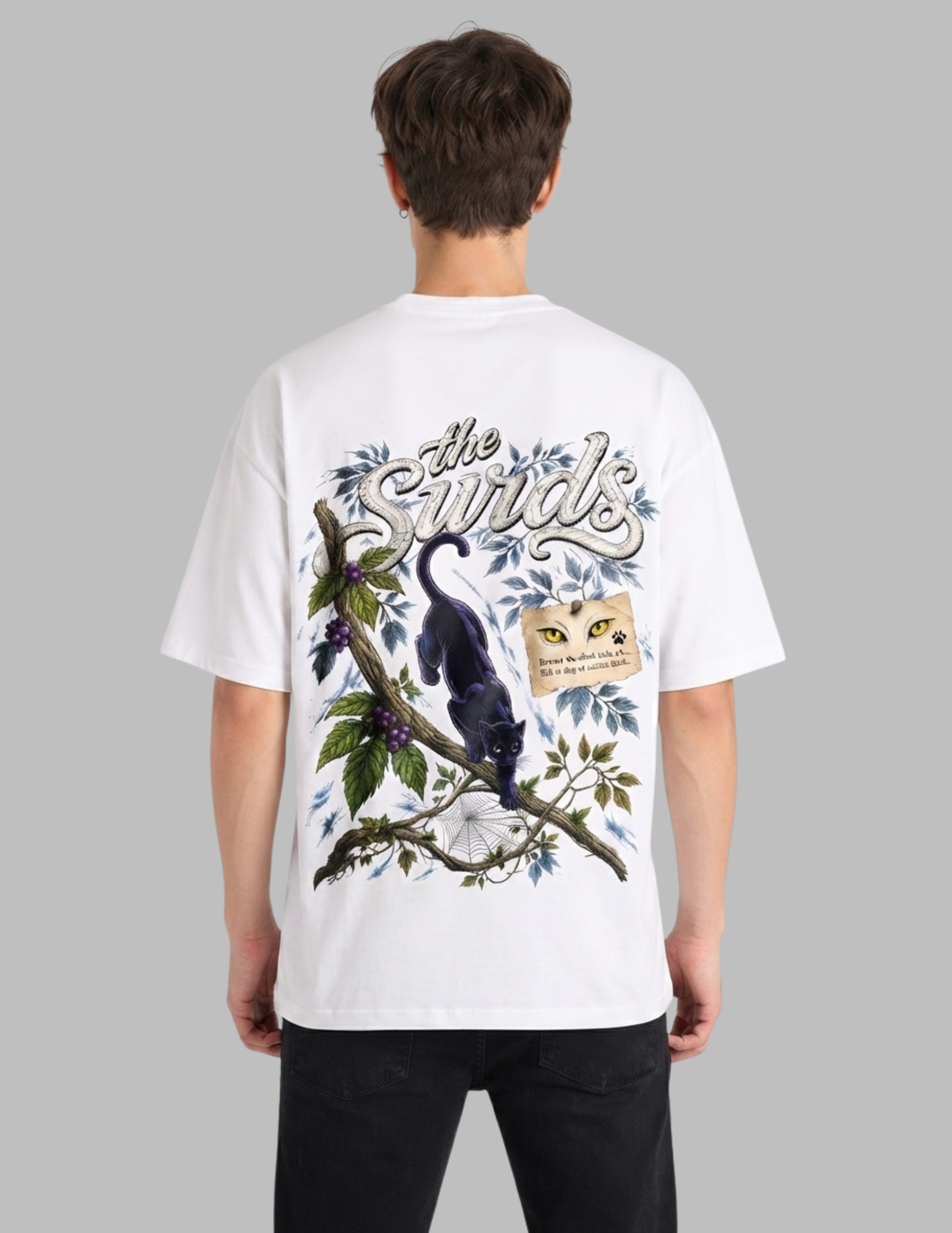 A man viewed from behind wearing a white graphic t-shirt with a detailed illustration of a black bird on a branch with blue leaves and the text 'the Bird'.
