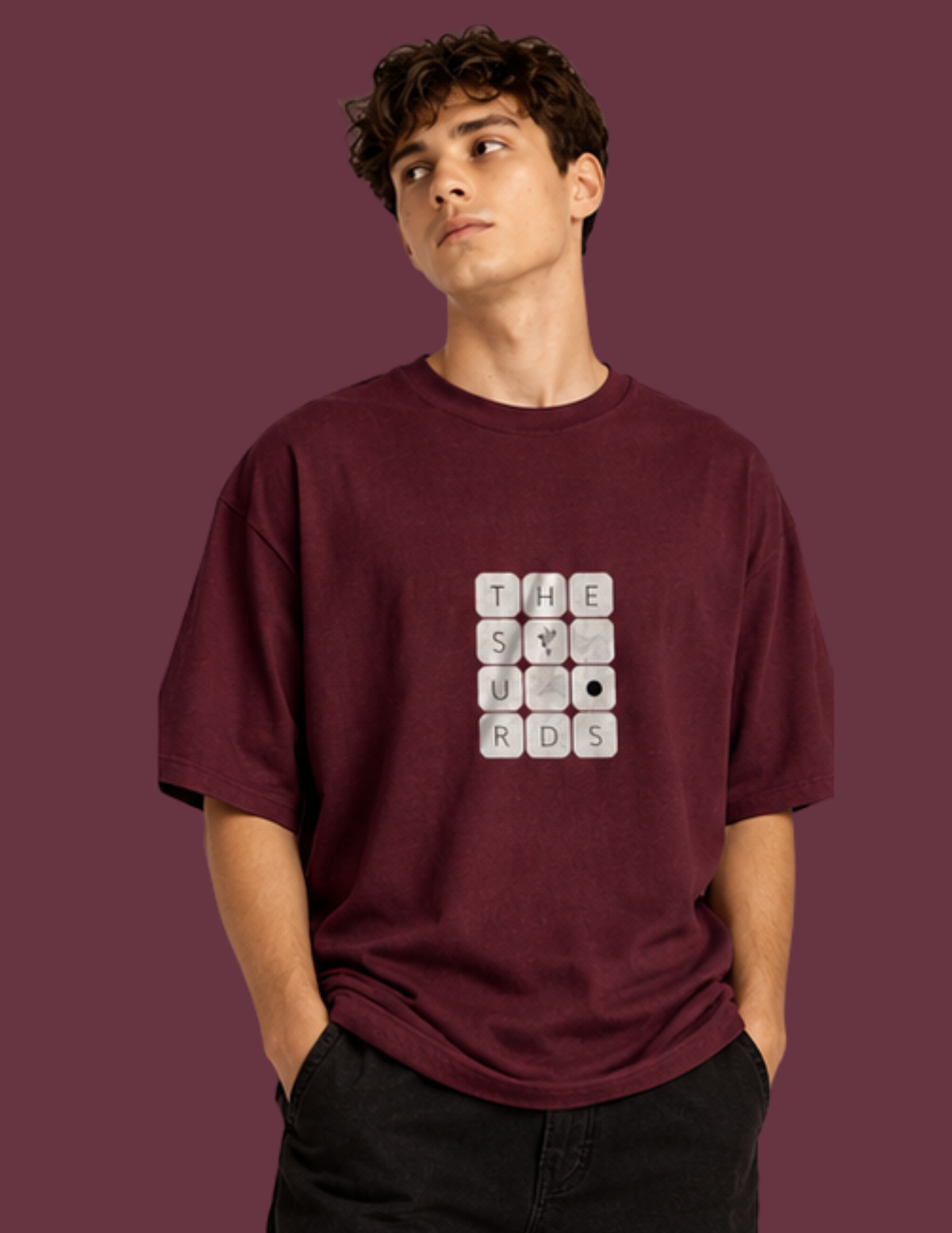 Play with words, wear your identity. The Surds Scrabble-inspired oversized T-shirt features a minimal tile-style graphic spelling out the brand name on a classic black base. Designed for a clean, effortless streetwear look.
