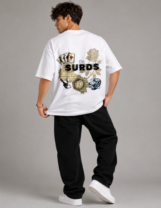 A man wearing a white t-shirt with a large graphic print on the back, paired with black pants and white sneakers, photographed from behind against a neutral gray studio background. The graphic features the text 'the SURDS' with playing cards, a rose, a clock, and dice.