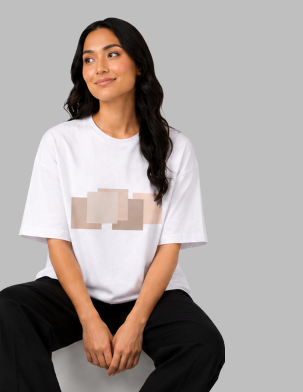 Woman wearing a white t-shirt with a graphic design on a gray background
