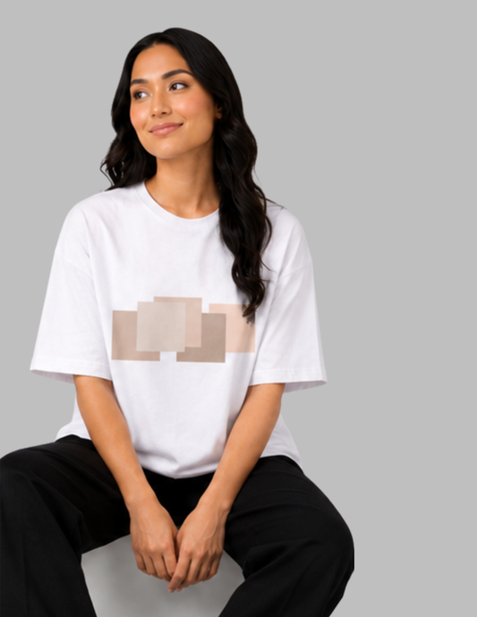 Woman wearing a white t-shirt with a graphic design on a gray background