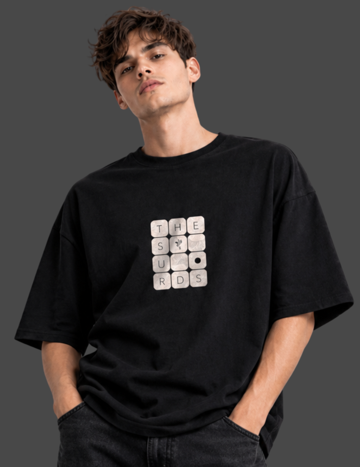 Play with words, wear your identity. The Surds Scrabble-inspired oversized T-shirt features a minimal tile-style graphic spelling out the brand name on a classic black base. Designed for a clean, effortless streetwear look.
