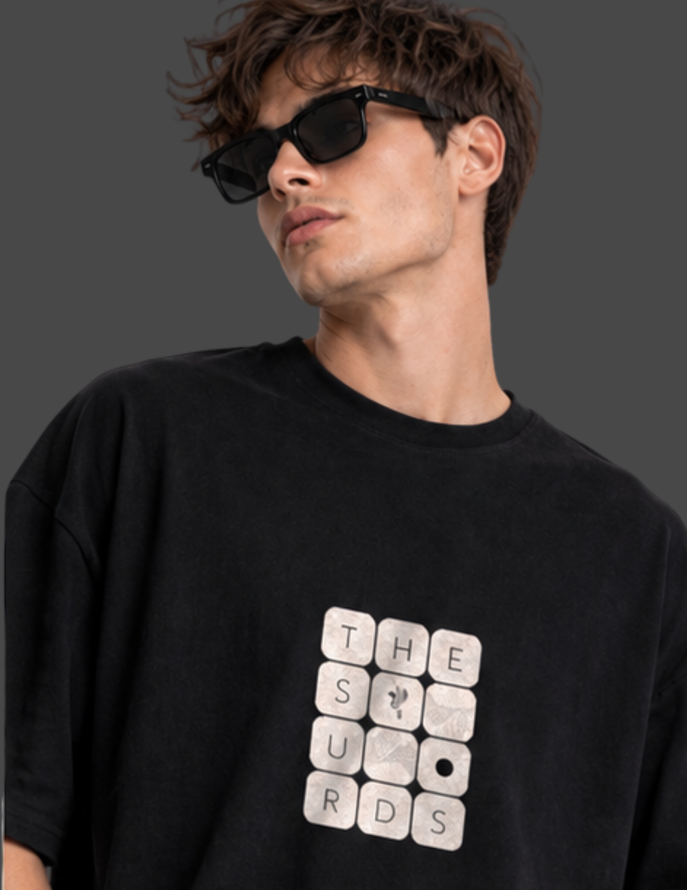 Play with words, wear your identity. The Surds Scrabble-inspired oversized T-shirt features a minimal tile-style graphic spelling out the brand name on a classic black base. Designed for a clean, effortless streetwear look.