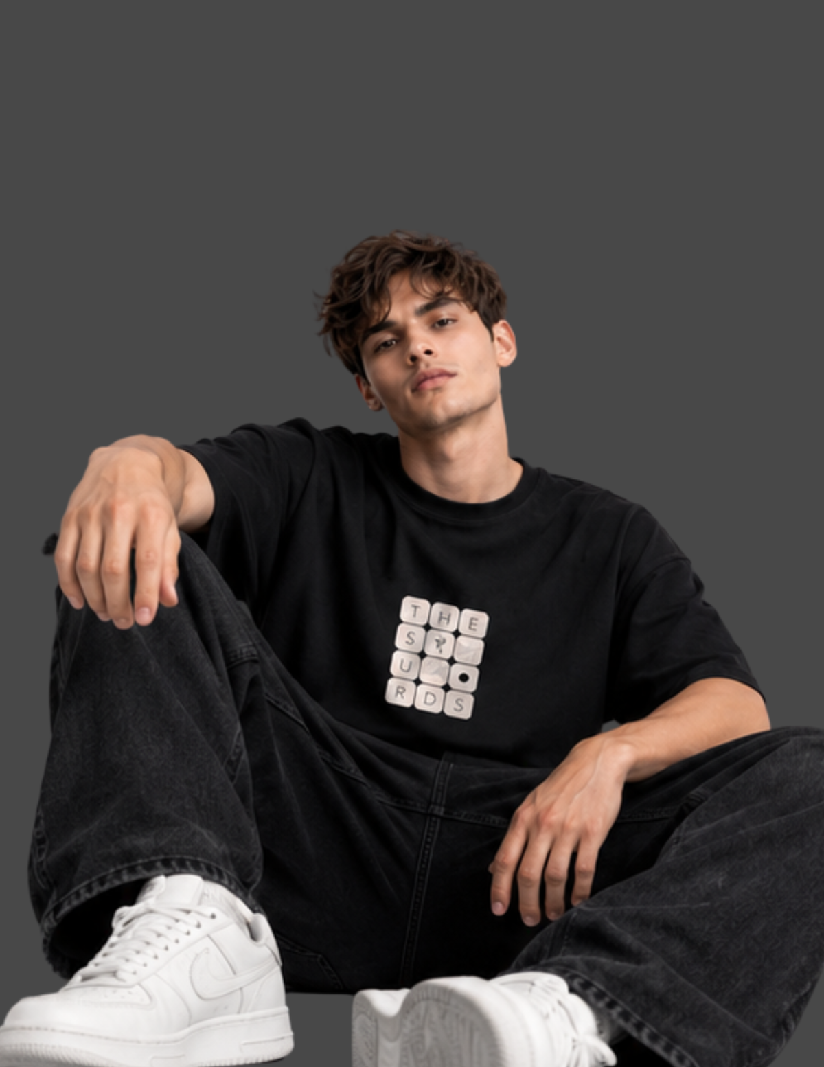 Play with words, wear your identity. The Surds Scrabble-inspired oversized T-shirt features a minimal tile-style graphic spelling out the brand name on a classic black base. Designed for a clean, effortless streetwear look.