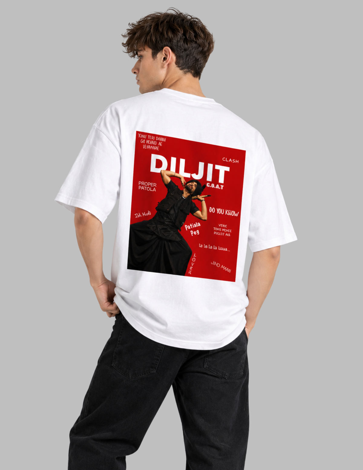 A man wearing a white t-shirt with a large red and black graphic print on the back, paired with black pants, shown from behind against a solid gray background.