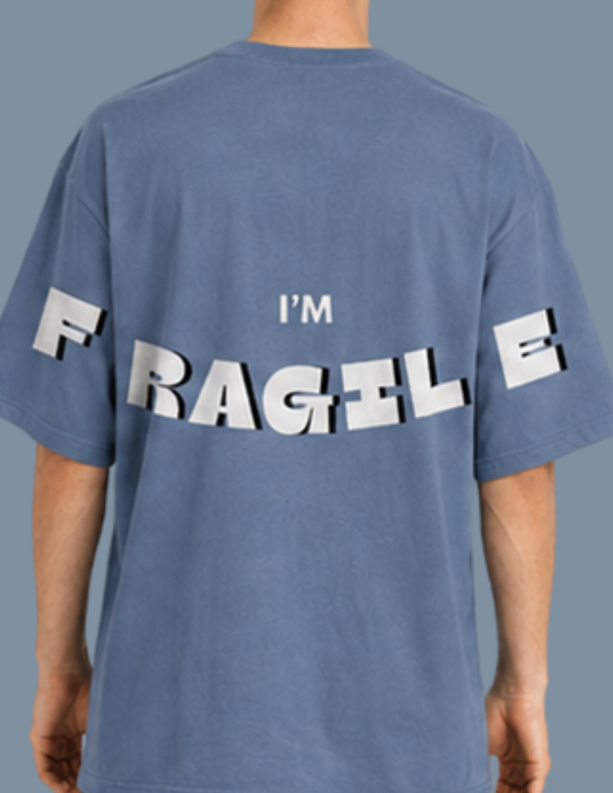 Blue t-shirt with 'I'm Fragile' text on the back against a gray background