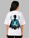Person wearing a white t-shirt with a graphic design on the back, featuring a silhouette of a person with deer antlers and a forest.