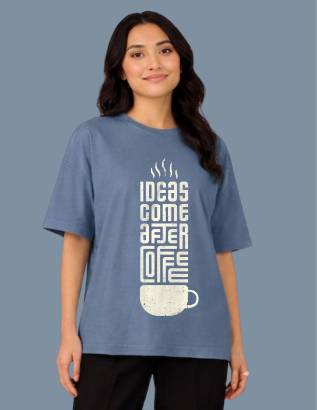 Person wearing a blue t-shirt with a coffee-themed design on a solid background