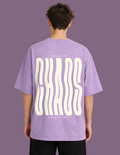 Person wearing a purple t-shirt with text on the back against a purple background