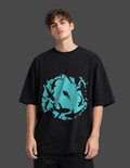 Person wearing a black t-shirt with a blue graphic design on a dark background