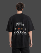Person wearing a black 'Harry Potter' t-shirt with a graphic design on the back.