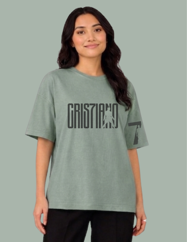 Person wearing a green t-shirt with text on a gray background