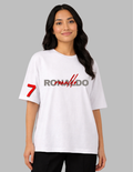 Person wearing a white t-shirt with red and black text on a gray background