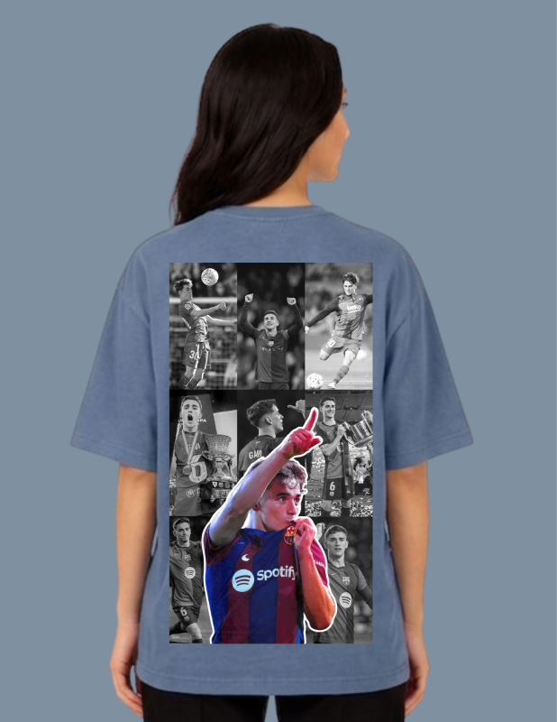 Person wearing a blue t-shirt with a collage of images on the back against a gray background