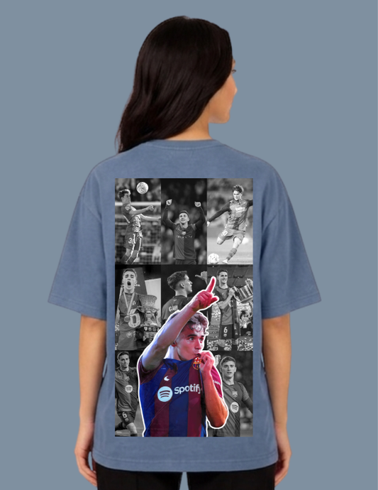 Person wearing a blue t-shirt with a collage of images on the back against a gray background