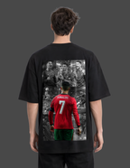 Person wearing a black t-shirt with a graphic of a soccer player in a red jersey on the back.