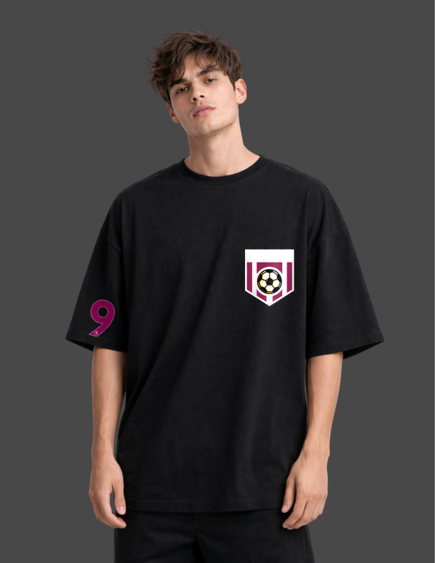 Person wearing a black t-shirt with a logo on a dark background