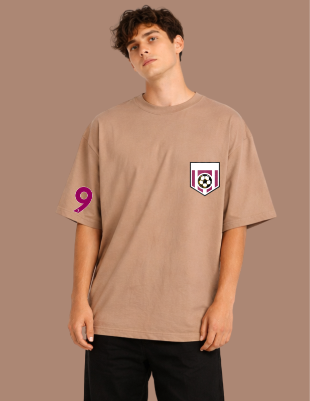 Man wearing a beige t-shirt with a logo and number on a brown background