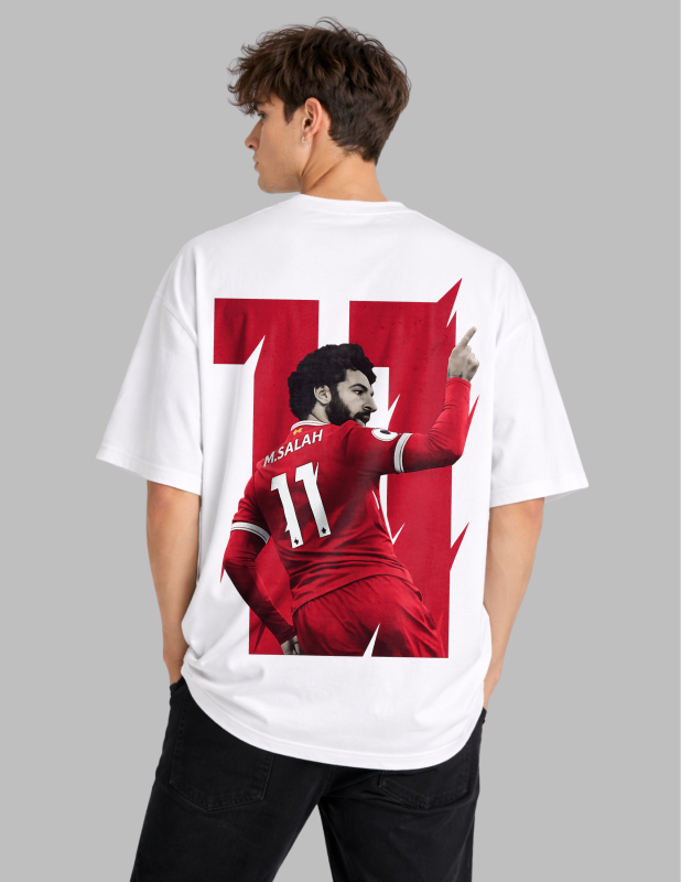 Person wearing a white t-shirt with a graphic of a soccer player in red on the back, on a gray background.