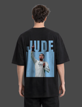 Person wearing a black t-shirt with a graphic of a football player and the name 'Jude' on the back.