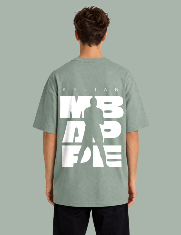 Person wearing a green t-shirt with white text on the back against a gray background