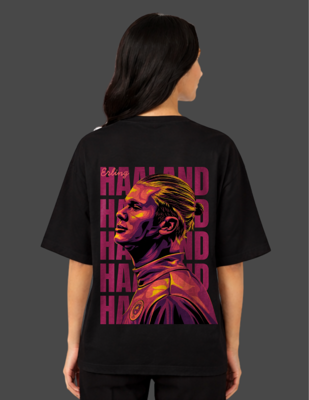 Person wearing a black t-shirt with a graphic design on the back against a gray background