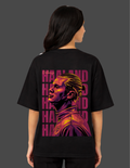 Person wearing a black t-shirt with a graphic design on the back against a gray background