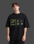 Person wearing a black t-shirt with green graphic designs on a dark background