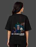 Person wearing a black t-shirt with images and text of a soccer player on the back