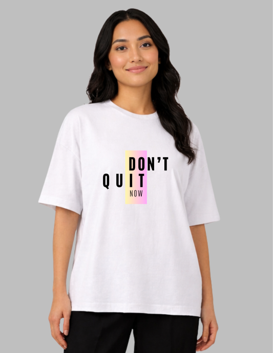Woman wearing a white t-shirt with 'DON'T QUIT NOW' text on a gray background