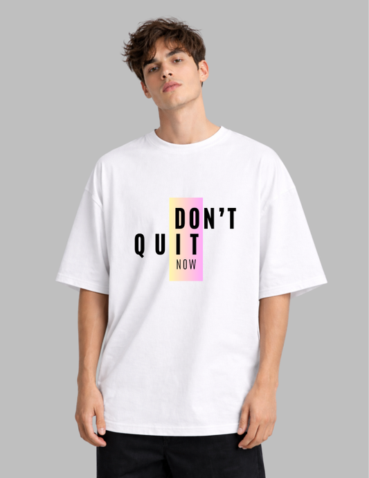 Person wearing a white t-shirt with 'DON'T QUIT NOW' text on a gray background