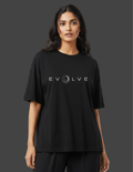 Person wearing a black t-shirt with 'EVOLVE' logo on a dark background