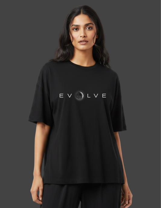 Person wearing a black t-shirt with 'EVOLVE' logo on a dark background