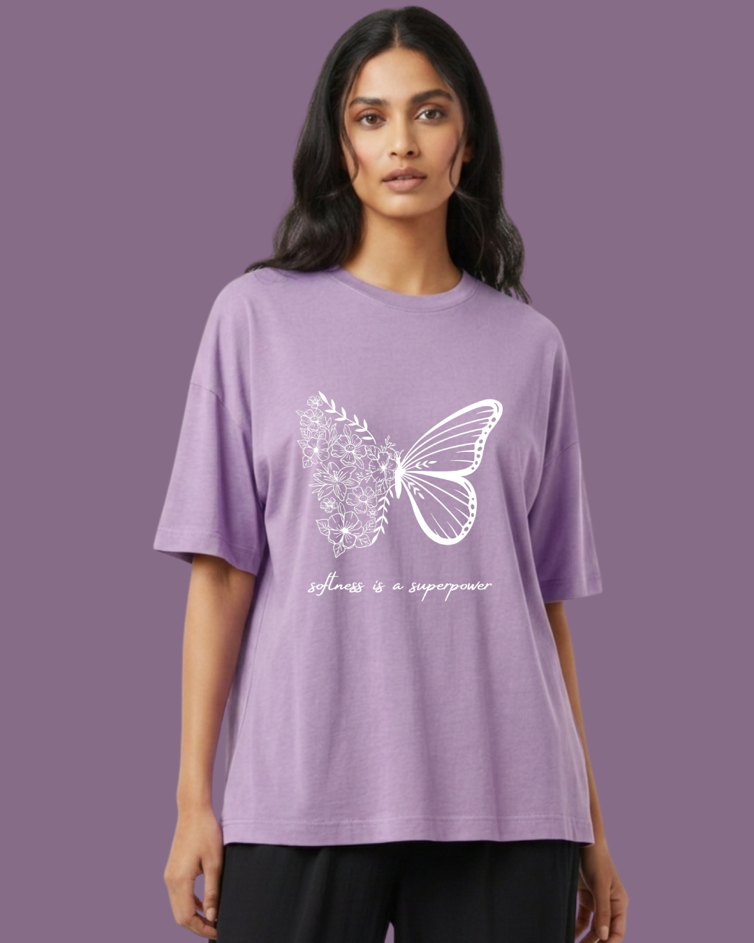 Woman wearing a purple t-shirt with a butterfly design and text on a purple background