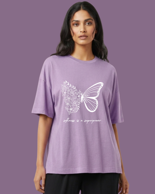 Woman wearing a purple t-shirt with a butterfly design and text on a purple background