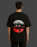 Black t-shirt with a graphic design on the back, featuring a moon and silhouette of people.
