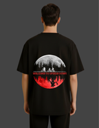 Black t-shirt with a graphic design on the back, featuring a moon and silhouette of people.