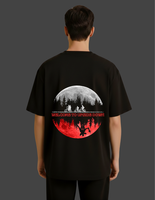 Black t-shirt with a graphic design on the back, featuring a moon and silhouette of people.