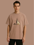 Man wearing a brown t-shirt with a graphic design on a brown background