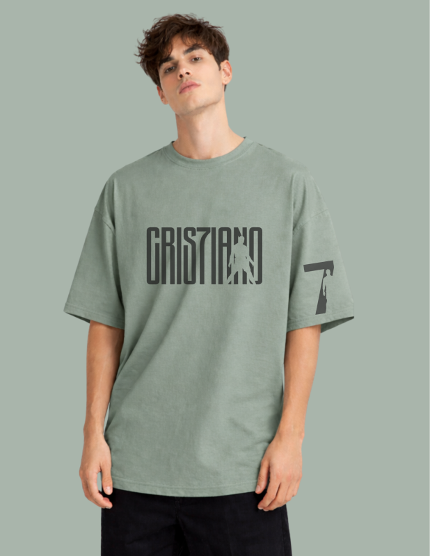Person wearing a green t-shirt with text on a gray background