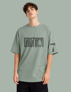 Person wearing a green t-shirt with text on a gray background