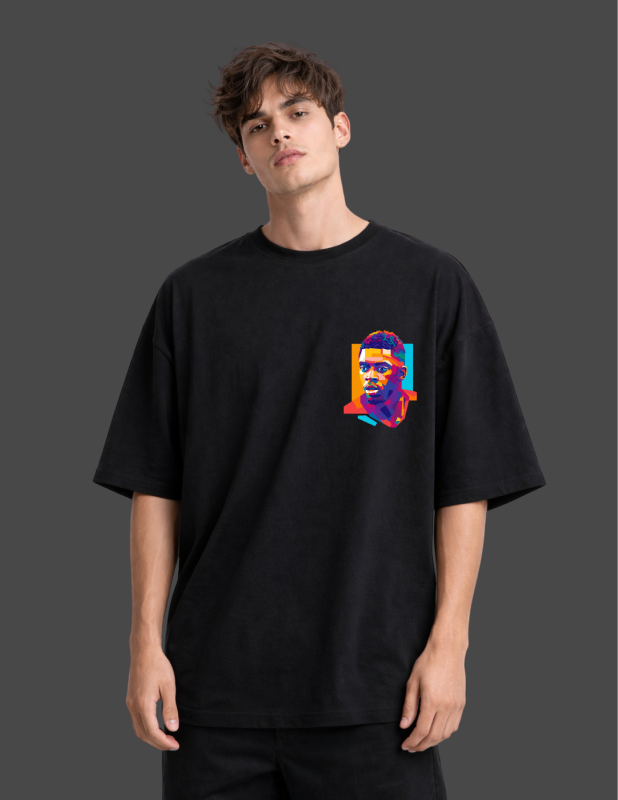 Person wearing a black t-shirt with a colorful graphic on a dark background