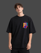 Person wearing a black t-shirt with a colorful graphic on a dark background