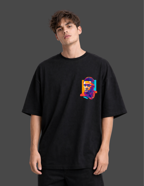 Person wearing a black t-shirt with a colorful graphic on a dark background