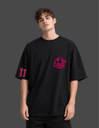 Person wearing a black t-shirt with a red logo and number on a dark background